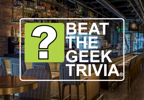 A modern bar interior with &ldquo;Beat The Geek Trivia&rdquo; branding and a large green question mark in a frame.